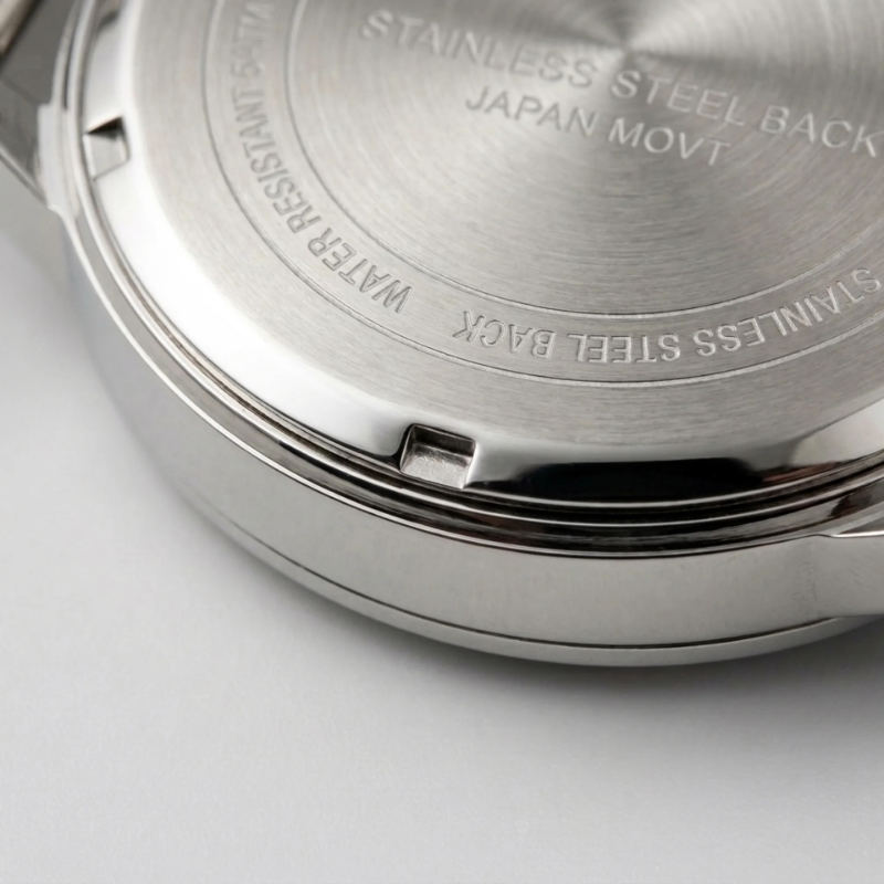 Close-up of screw-back caseback on a water resistant watch showing the notches around the edge