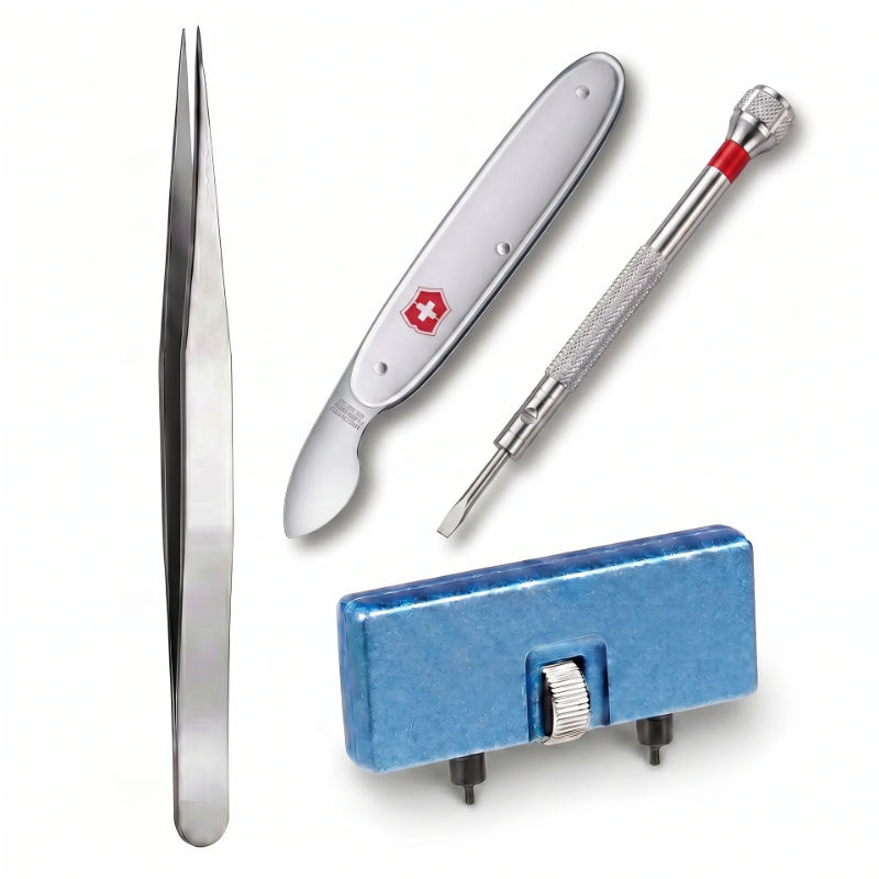 Watch battery change kit laid out on lint-free cloth — case back opener, tweezers, and button cell batteries