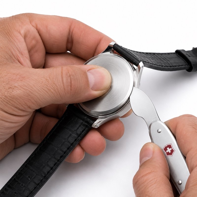 Snap-on caseback being opened with a case knife